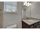 Bathroom with a granite countertop, dark wood vanity, and a window to the outside allowing for some natural light at 449 Bahama Grande Blvd, Apollo Beach, FL 33572