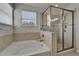 Bathroom featuring a soaking tub, a glass-enclosed shower, and a window for natural light at 449 Bahama Grande Blvd, Apollo Beach, FL 33572
