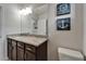 Bathroom with a dark wood vanity, granite countertop, nautical-themed decor, and a large, well-lit mirror at 449 Bahama Grande Blvd, Apollo Beach, FL 33572