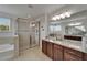 Bathroom with glass-enclosed shower, granite countertop, and a large mirror at 449 Bahama Grande Blvd, Apollo Beach, FL 33572