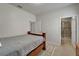 Bedroom with tan carpet, wooden bed frame and bathroom access at 449 Bahama Grande Blvd, Apollo Beach, FL 33572