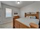 Comfortable bedroom showcases a wooden bed frame, dresser, and window, creating a cozy retreat at 449 Bahama Grande Blvd, Apollo Beach, FL 33572