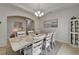 Dining area with a long table, chandelier and decorative display cabinet, offering a warm atmosphere at 449 Bahama Grande Blvd, Apollo Beach, FL 33572