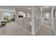 Spacious hallway featuring arched entryways, neutral walls, and plush carpeting, leading into the adjacent living area at 449 Bahama Grande Blvd, Apollo Beach, FL 33572