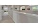 Bright hallway featuring an arched entry and neutral walls that provides seamless flow to multiple rooms at 449 Bahama Grande Blvd, Apollo Beach, FL 33572