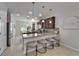 Stylish kitchen boasts granite countertops, dark wood cabinetry, pendant lighting, and four stools at the breakfast bar at 449 Bahama Grande Blvd, Apollo Beach, FL 33572