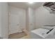 The laundry room features a washer, dryer and storage shelving at 449 Bahama Grande Blvd, Apollo Beach, FL 33572
