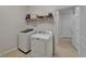 The laundry room features a washer, dryer and storage shelving at 449 Bahama Grande Blvd, Apollo Beach, FL 33572