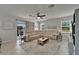 Spacious living area with a large sectional sofa, ceiling fan, and view of the outdoor patio at 449 Bahama Grande Blvd, Apollo Beach, FL 33572
