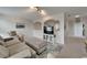 Inviting living space with a sofa, ottoman, recliner seating, and a TV with arched design that opens to other rooms at 449 Bahama Grande Blvd, Apollo Beach, FL 33572