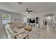 Inviting living room showcasing a sectional sofa, entertainment center, and adjacent entryway at 449 Bahama Grande Blvd, Apollo Beach, FL 33572