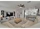 Open living area with a sectional sofa, media console, and bar stool seating at the kitchen counter at 449 Bahama Grande Blvd, Apollo Beach, FL 33572