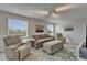 Cozy living room area with recliner seating, a sofa, an ottoman, and plenty of natural light from the windows at 449 Bahama Grande Blvd, Apollo Beach, FL 33572