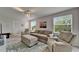 Comfortable living room featuring a sofa, two armchairs, an ottoman, recessed lighting, and natural light from the windows at 449 Bahama Grande Blvd, Apollo Beach, FL 33572