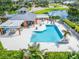 Outdoor pool and entertainment area with tables, chairs, and lounging area offer a relaxing resort-style experience at 449 Bahama Grande Blvd, Apollo Beach, FL 33572