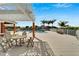 Outdoor pool with table and chairs on deck overlooks palm trees and green landscaping within the community at 449 Bahama Grande Blvd, Apollo Beach, FL 33572