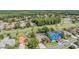 A high aerial shot displaying homes with green fairways, mature trees and blue roofs at 5029 Camberley Ln, Oldsmar, FL 34677