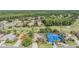 Aerial view showcasing the neighborhood's layout with lush green spaces, golf course, and tiled roofs at 5029 Camberley Ln, Oldsmar, FL 34677