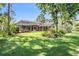 Expansive backyard featuring a screened-in patio with ample space for outdoor enjoyment and lush greenery at 5029 Camberley Ln, Oldsmar, FL 34677