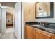 Bathroom features a granite countertop, stylish cabinets, and neutral wall coverings at 5029 Camberley Ln, Oldsmar, FL 34677