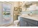 Bright bathroom with a door to the pool area and granite countertop at 5029 Camberley Ln, Oldsmar, FL 34677