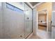 Bathroom with a large glass-enclosed shower and view into adjacent bedroom at 5029 Camberley Ln, Oldsmar, FL 34677