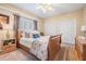 Cozy bedroom features a ceiling fan, a bright window and ample closet space at 5029 Camberley Ln, Oldsmar, FL 34677