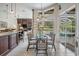 Dining area features a glass table with six chairs, tiled flooring, and views of the outdoor screened-in pool area at 5029 Camberley Ln, Oldsmar, FL 34677