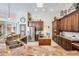 Bright kitchen features stainless-steel appliances, custom wood cabinets, granite countertops, and an island at 5029 Camberley Ln, Oldsmar, FL 34677