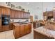 Well-appointed kitchen with custom wood cabinets, granite countertops, and an island cooktop at 5029 Camberley Ln, Oldsmar, FL 34677