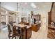 Bright kitchen with a skylight, brown cabinets, stainless steel appliances, granite countertops, and a breakfast bar with seating at 5029 Camberley Ln, Oldsmar, FL 34677