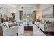 Bright living room with high ceilings, neutral decor, and sliding glass doors to outdoor pool area at 5029 Camberley Ln, Oldsmar, FL 34677