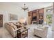 Inviting living room with a fireplace, built-in shelving, comfortable seating, and plenty of natural light at 5029 Camberley Ln, Oldsmar, FL 34677