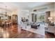 Spacious living room with hardwood floors, comfortable seating, and an open floor plan leading to the dining area at 5029 Camberley Ln, Oldsmar, FL 34677