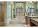 Beautiful main bathroom featuring a soaking tub, tiled shower, and a dual sink vanity at 5029 Camberley Ln, Oldsmar, FL 34677