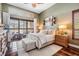 Serene main bedroom with plush bedding, wood floors, and large windows offering ample natural light at 5029 Camberley Ln, Oldsmar, FL 34677