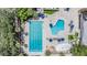 Aerial view of a community swimming pool area with multiple pools, lounge chairs, and recreational features at 5029 Camberley Ln, Oldsmar, FL 34677