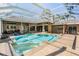 Stunning pool and spa with an enclosure, loungers, and well-maintained patio at 5029 Camberley Ln, Oldsmar, FL 34677