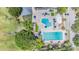 Aerial view of the community pool area with multiple pools, lounge chairs, and play area at 5029 Camberley Ln, Oldsmar, FL 34677