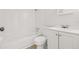 Bright bathroom featuring a white tiled shower-tub and vanity at 5622 Tangerine S Ave, Gulfport, FL 33707
