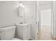 Clean bathroom with a vanity, toilet, and view of the hallway at 5622 Tangerine S Ave, Gulfport, FL 33707