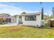 A quaint white home showcasing a modern design with black trim, enhancing its curb appeal at 5622 Tangerine S Ave, Gulfport, FL 33707