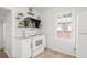 Modern kitchen with white cabinets, stainless-steel appliances, and subway tile backsplash providing a clean and efficient workspace at 5622 Tangerine S Ave, Gulfport, FL 33707