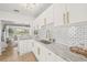Beautiful white kitchen featuring modern subway tiles and stone countertops at 5622 Tangerine S Ave, Gulfport, FL 33707