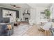 Open-concept living room with brick fireplace, wood floors, and stylish furnishings, creating an inviting atmosphere at 5622 Tangerine S Ave, Gulfport, FL 33707
