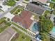 An elevated view showcases the home, fenced-in backyard with pool, and surrounding neighborhood at 5812 Blossom Ave, Tampa, FL 33614