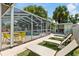 Backyard featuring a screened pool enclosure and sunny lounge area for relaxing outdoors at 5812 Blossom Ave, Tampa, FL 33614