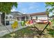 Lush backyard with colorful seating, a pool, and a relaxing hammock for outdoor enjoyment at 5812 Blossom Ave, Tampa, FL 33614