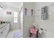 Tiled bathroom with glass-enclosed shower and coastal-themed decorations at 5812 Blossom Ave, Tampa, FL 33614