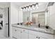 Bright bathroom featuring double sinks with granite counters at 5812 Blossom Ave, Tampa, FL 33614